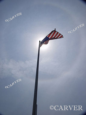  Crystalline Halo
Ice crystals high in the sky form complete halo around the sun.
The American flag and pole are curved from the effects of the wide angle lens.
Keywords: halo; ice; sun; flag; circle; arc; twilight; Beverly; art; photograph; picture; print; beverly